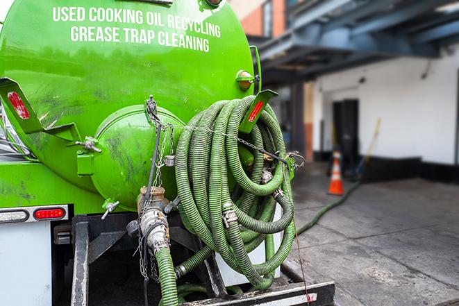 heavy-duty vacuum truck pumping out a grease trap in Addison